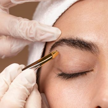 woman-doing-eyebrow-treatment-her-client